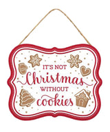 This image shows the sign that is white with a red border and reads "It's Not Christmas Without Cookies."