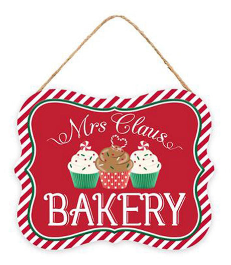 This sign is red with a red and white striped border. It reads "MRS. CLAUS BAKERY" and features three cupcakes.