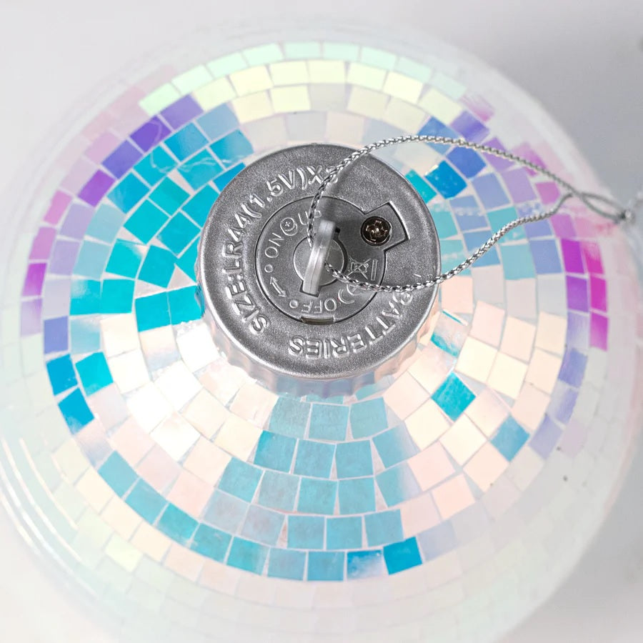 This image shows the On/Off switch on the top of the silver cap of this ornament.