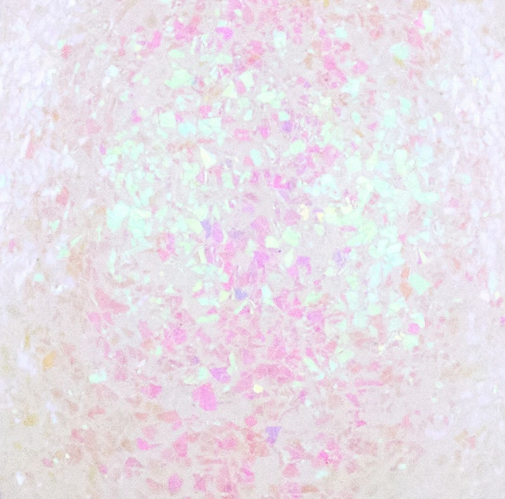 This is an up close view of the iridescent confetti glitter. It appears white and pink.