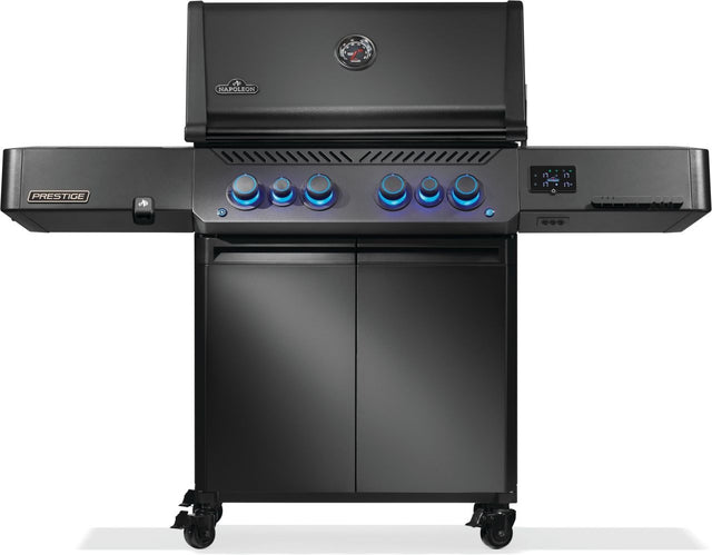 Black Napoleon grill. There is a built-in thermometer on the lid, there are two shelves outstretched, six buttons and a cabinet that opens up underneath. This is the front view.