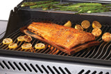 This is a lifestyle image showing different foods being cooked on the grill.