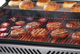 This is a lifestyle image showing different foods being cooked on the grill.