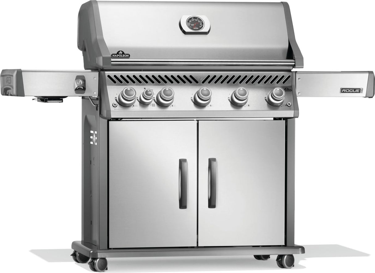 Silver and gray Napoleon grill. There is a built-in thermometer on the lid, there are two shelves outstretched, six buttons and a cabinet that opens up underneath. This is the left side view.