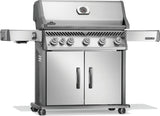 Silver and gray Napoleon grill. There is a built-in thermometer on the lid, there are two shelves outstretched, six buttons and a cabinet that opens up underneath. This is the left side view.