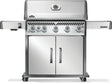 Silver and gray Napoleon grill. There is a built-in thermometer on the lid, there are two shelves outstretched, six buttons and a cabinet that opens up underneath. This is the front view.