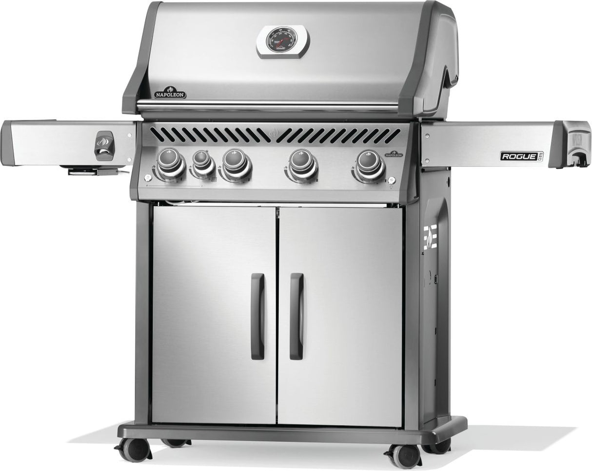 Silver and gray Napoleon grill. There is a built-in thermometer on the lid, there are two shelves outstretched, five buttons and a cabinet that opens up underneath. This is the right side view.