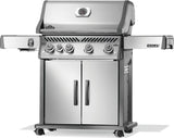 Silver and gray Napoleon grill. There is a built-in thermometer on the lid, there are two shelves outstretched, five buttons and a cabinet that opens up underneath. This is the right side view.