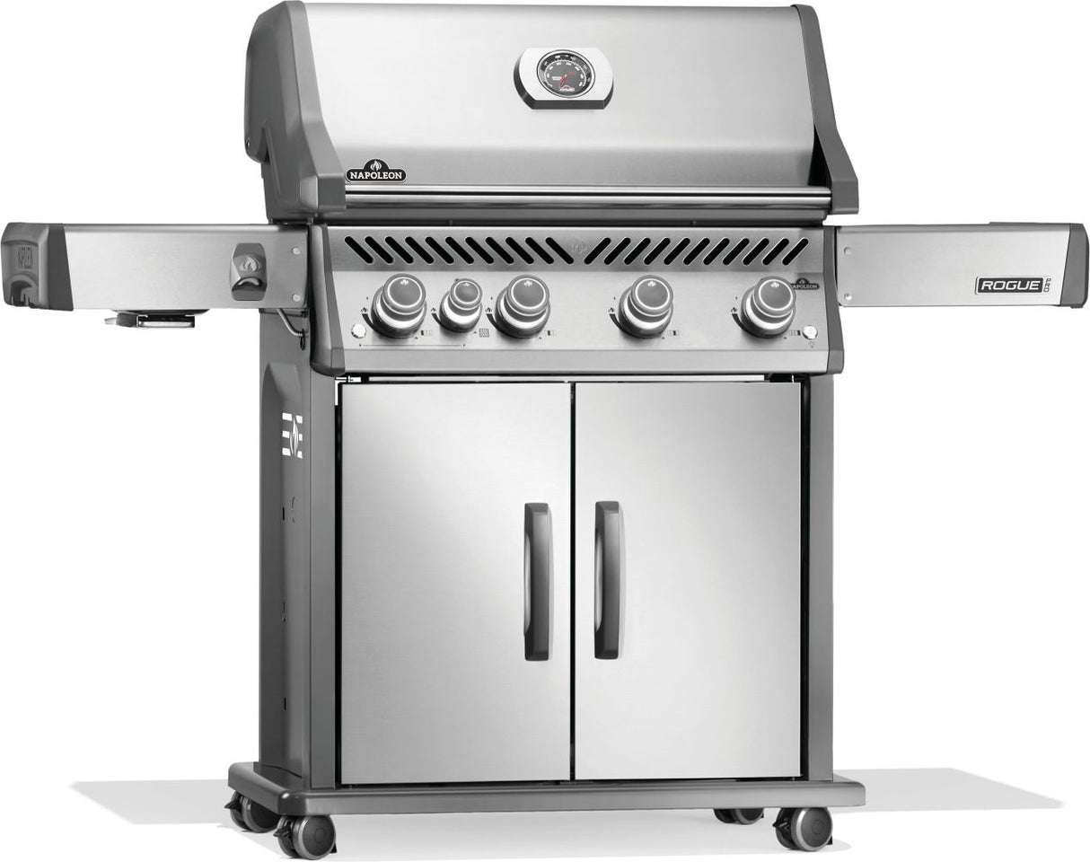 Silver and gray Napoleon grill. There is a built-in thermometer on the lid, there are two shelves outstretched, five buttons and a cabinet that opens up underneath. This is the left side view.