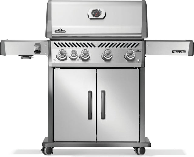 Silver and gray Napoleon grill. There is a built-in thermometer on the lid, there are two shelves outstretched, five buttons and a cabinet that opens up underneath. This is the front view.