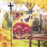Yellow flag that features a sunflower, leaves, mushrooms, a large pumpkin and a blue bird sitting on the pumpkin.