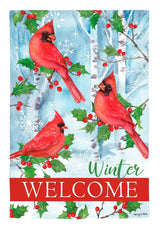 Light blue flag that reads "WELCOME WINTER." There are birch trees, snowflakes, cardinals and holly leaves and berries.