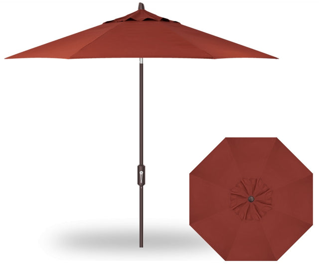 A red colored market umbrella with a bronze pole.