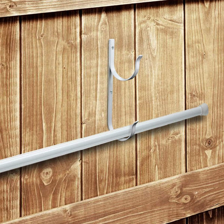 This picture shows what the hanger will look like screwed into the fence and holding a pole.