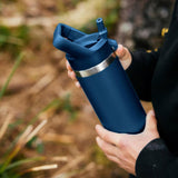 Navy colored YETI water bottle. This lifestyle image shows someone holding it.