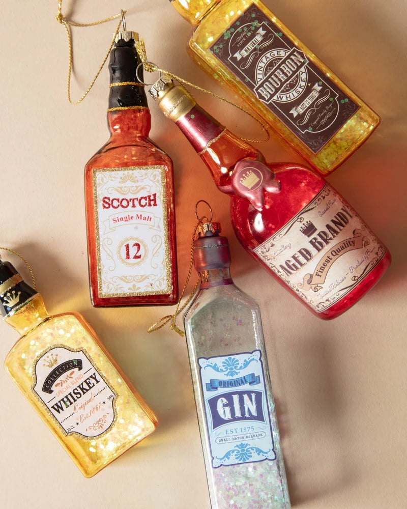 Ornament shaped like a miniature bottle of alcohol. One ornament is red and reads "Aged Brandy." One ornament is yellow and reads "Whiskey." One ornament is orange and reads "Scotch." One ornament is yellow and reads "Bourbon." One ornament is light blue and reads "Gin." Each ornament has glitter inside.