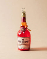 Ornament shaped like a miniature bottle of alcohol. One ornament is red and reads "Aged Brandy." One ornament is yellow and reads "Whiskey." One ornament is orange and reads "Scotch." One ornament is yellow and reads "Bourbon." One ornament is light blue and reads "Gin." Each ornament has glitter inside.