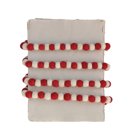 Garland made out of red and white felt balls.