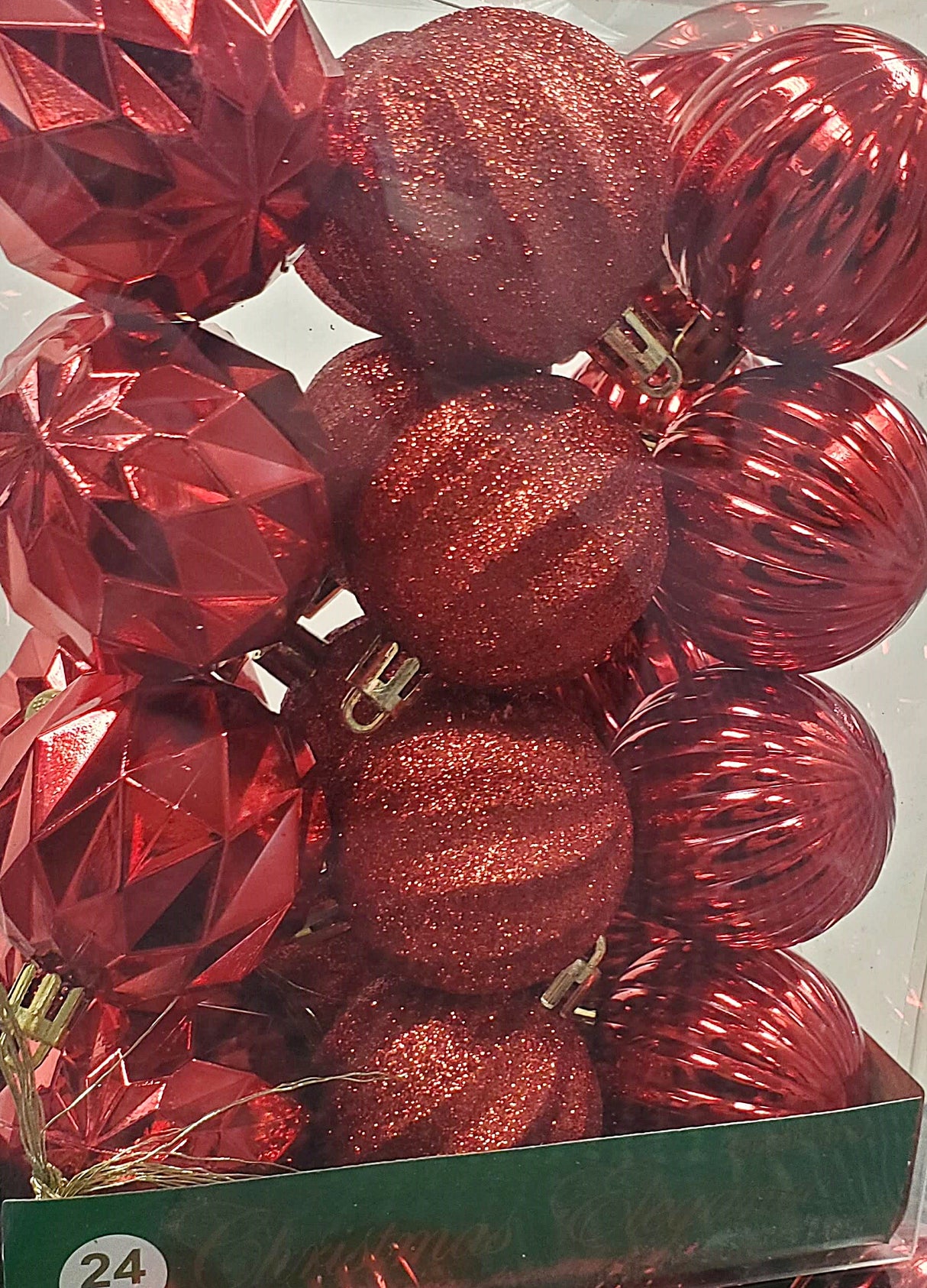 Set of 24 ornaments. This is a pack of red ornaments in different textures. Red ornaments in different textures, some of them have glitter on them.