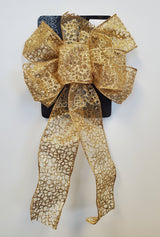 This image shows the gold sheer bow. It has six loops and an intricate shiny gold design.