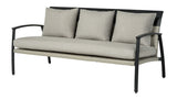 A sofa made up of aluminum and wicker with tan cushions