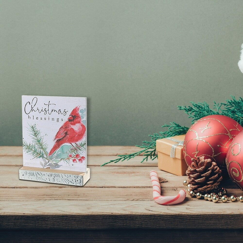 This is a lifestyle image showing one of the decorations on a wooden table along with other Christmas decorations.