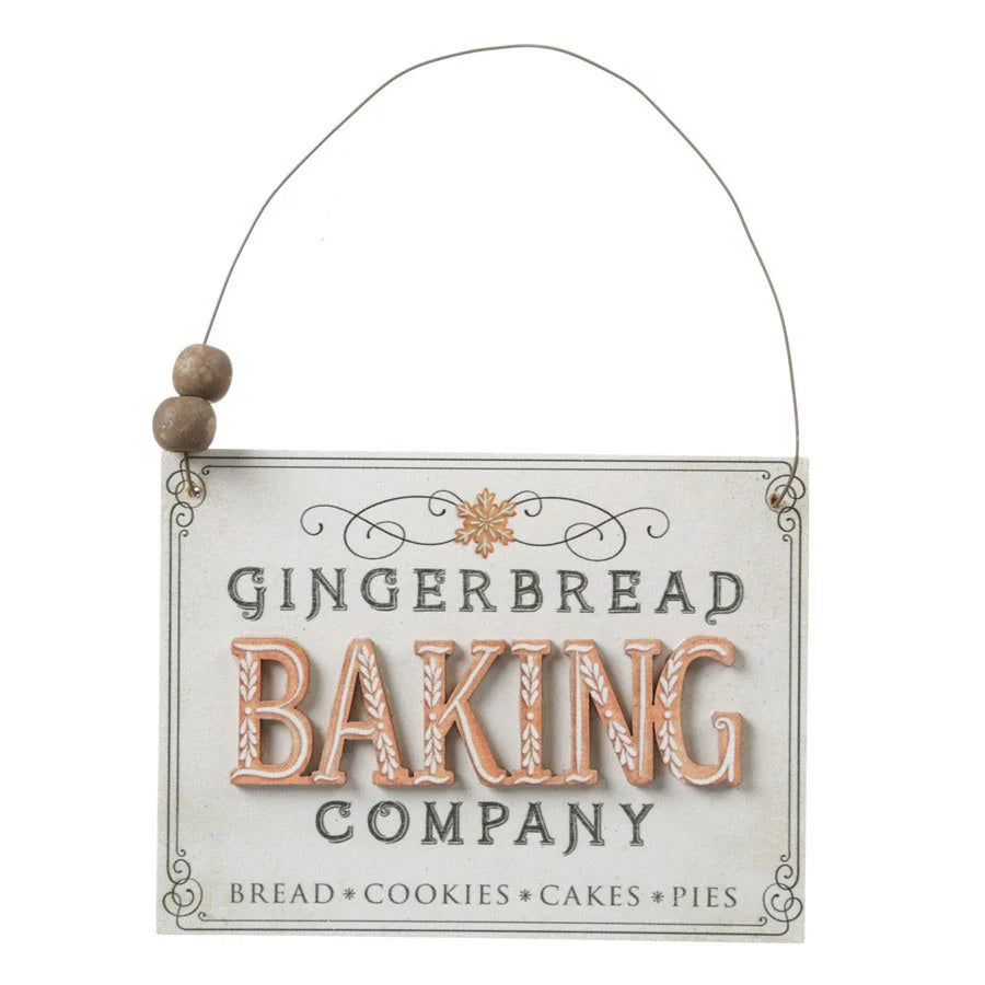 Ornament shaped like a holiday sign. One sign reads "Warm Wishes." One sign reads "Gingerbread Baking Company. Bread, Cookies, Cakes, Pies." Each sign has a dainty border and small wooden beads on the wire holder.