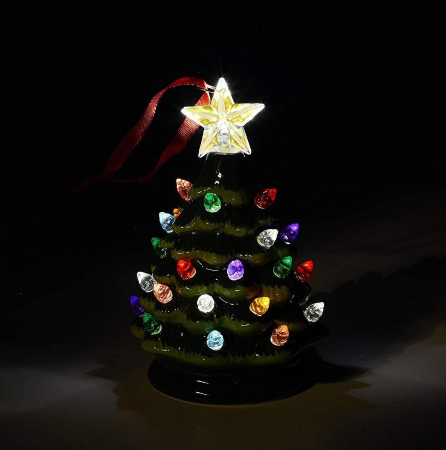 Light up Christmas decoration. Ornament shaped like a decorated tree with a star on top. Lights on the tree are multi-colored.