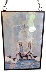 Christmas ornament with a painted Nativity Scene on it. Designed to look like stained glass.