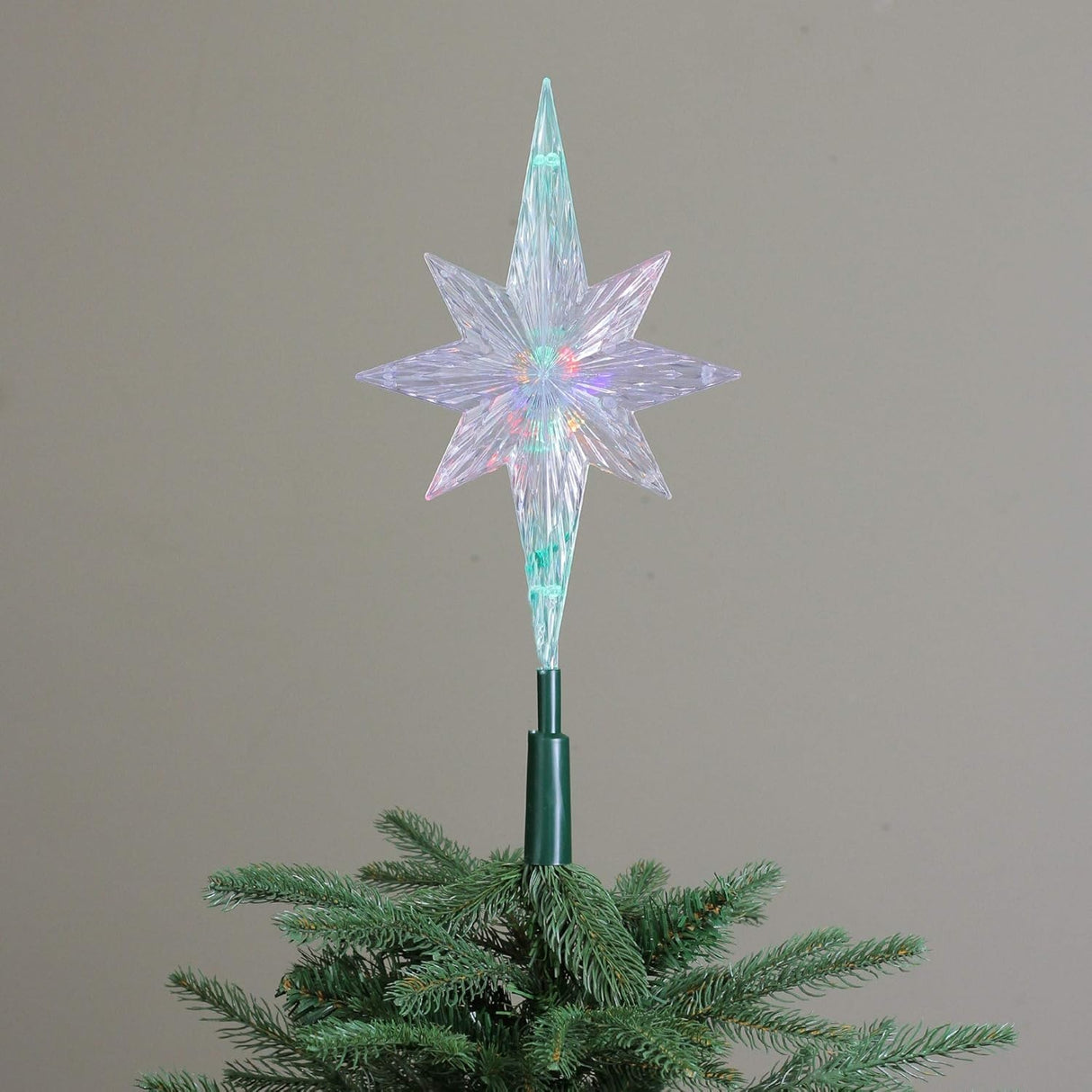 Clear Christmas tree star that shines with the color-changing LED lights inside.