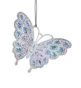 Butterfly shaped ornament decorated with opalescent, light blue and light purple colors and glitter.