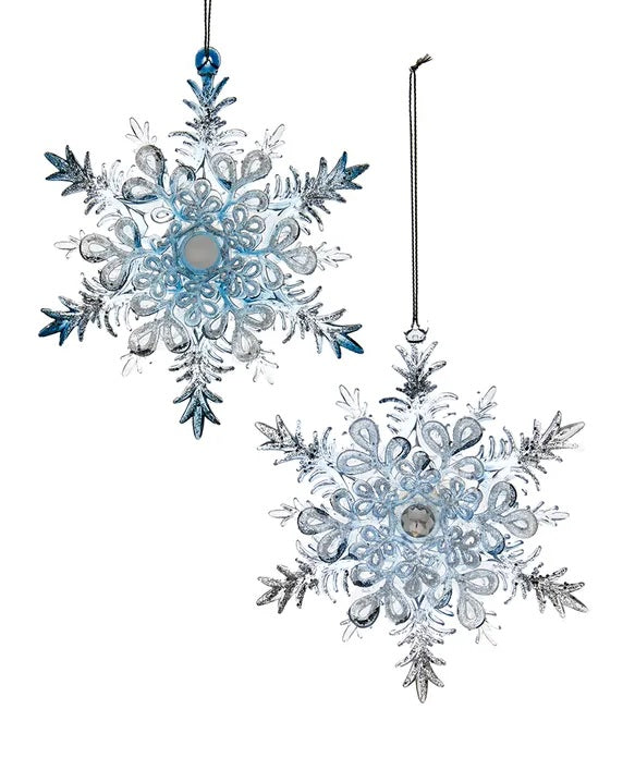 Ornaments shaped like snowflakes covered in blue and silver glitter.