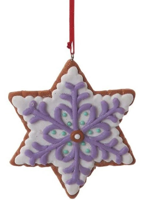 Ornament designed to look like a frosted gingerbread cookie. Two are shaped like six-point stars and two are shaped like snowflakes. They're all decorated with intricate designs. You get one, this image shows all four options.