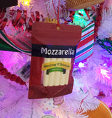 An ornament shaped like a package filled with string cheese. It reads "Mozzarella. String cheese snacks. Low moisture part-skim mozzarella natural cheese. A natural source of calcium with 7 g of Protein. 12 90 calorie snacks."