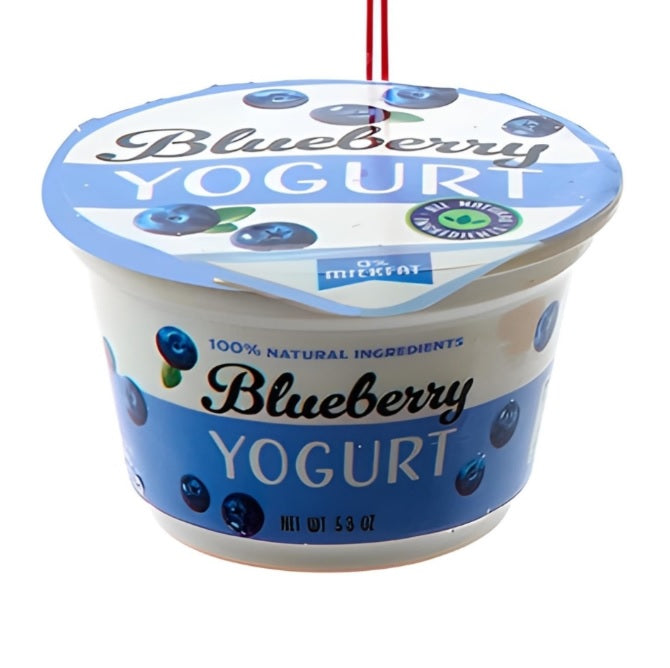 Ornament shaped like a cup of yogurt. One ornament is white and red and "flavored" strawberry. One ornament is white and blue and "flavored" blueberry. One ornament is white and orange and "flavored" peach. One ornament is white and blue and "flavored" Greek-style.