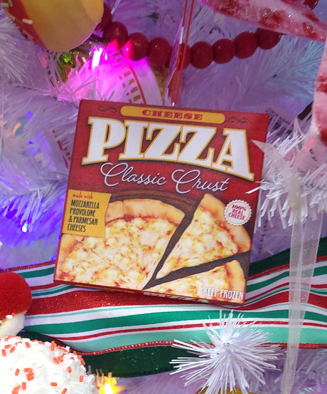 Ornament shaped like a frozen pizza box. One ornament looks like a Supreme pizza with a classic crust. One ornament looks like a Pepperoni pizza with a classic crust. One ornament looks like a Cheese pizza with a classic crust. One ornament looks like a gluten free Garden Veggie pizza with a cauliflower crust.