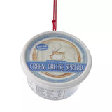 Plastic ornaments shaped like different party dips. One is a red container that reads "Classic Hummus." One is a green container that reads "French Onion Sour Cream Dip." One is a blue container that reads "Cream Cheese Spread."