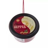 Plastic ornaments shaped like different party dips. One is a red container that reads "Classic Hummus." One is a green container that reads "French Onion Sour Cream Dip." One is a blue container that reads "Cream Cheese Spread."