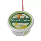 Plastic ornaments shaped like different party dips. One is a red container that reads "Classic Hummus." One is a green container that reads "French Onion Sour Cream Dip." One is a blue container that reads "Cream Cheese Spread."