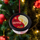 Plastic ornaments shaped like different party dips. One is a red container that reads "Classic Hummus." One is a green container that reads "French Onion Sour Cream Dip." One is a blue container that reads "Cream Cheese Spread."