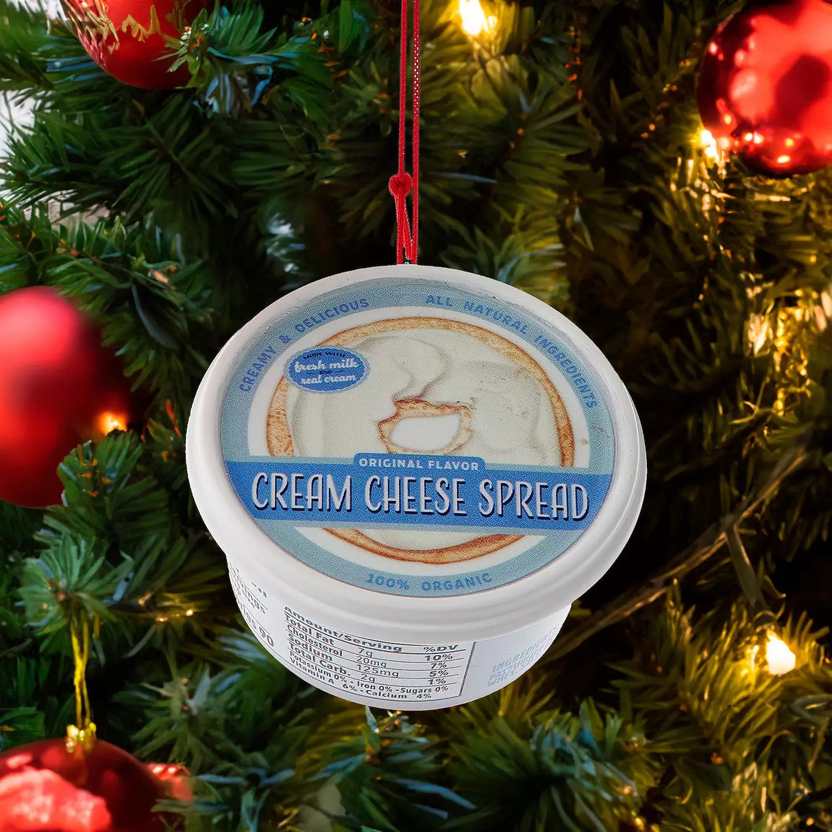 Plastic ornaments shaped like different party dips. One is a red container that reads "Classic Hummus." One is a green container that reads "French Onion Sour Cream Dip." One is a blue container that reads "Cream Cheese Spread."