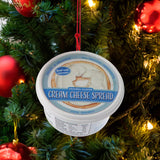 Plastic ornaments shaped like different party dips. One is a red container that reads "Classic Hummus." One is a green container that reads "French Onion Sour Cream Dip." One is a blue container that reads "Cream Cheese Spread."