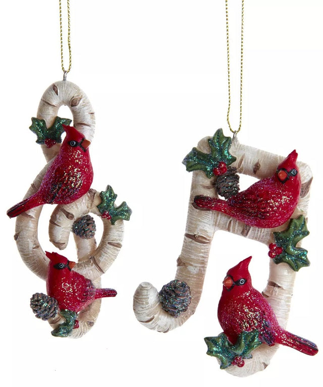 One ornament is shaped like a treble clef. One ornament is shaped like a slanted beamed sixteenth note. Each ornament is designed to look like it's made of birch tree and features glittered holly leaves, berries and pine cone accents.