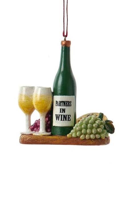 Ornament shaped like a plate with wine and cheese. One ornament features a bottle of red wine that reads "Working nine to wine." One ornament features a green bottle that reads "Partners in Wine." Each ornament features red and green grapes, wine glasses and some cheese.