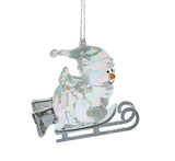 Opalescent snowman ornaments. This snowman is wearing winter clothes and is laying on a sled.