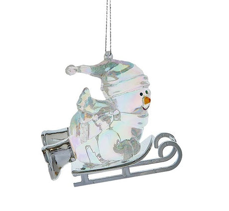 Opalescent snowman ornaments. This snowman is wearing winter clothes and is laying on a sled.