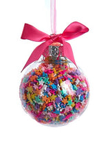 Glass bauble ornament with multi-colored sprinkles inside. One ornament features round sprinkles.
One ornament features star sprinkles. One ornament features tube sprinkles. One ornament features heart sprinkles. Each ornament is tied with a hot pink bow.
