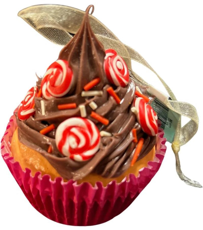 Christmas ornaments shaped like cupcakes with different colored frosting and candies on them.