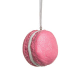 Ornaments shaped like a macaron cookie. One is pink, one is blue and one is green. They're all decorated with glitter to appear covered in sugar.