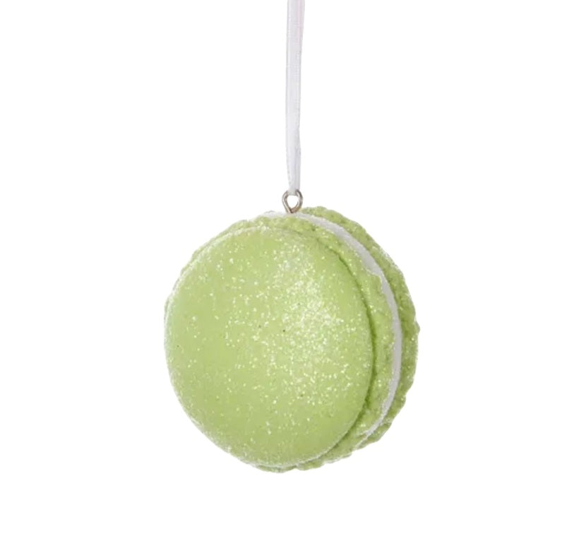 Ornaments shaped like a macaron cookie. One is pink, one is blue and one is green. They're all decorated with glitter to appear covered in sugar.